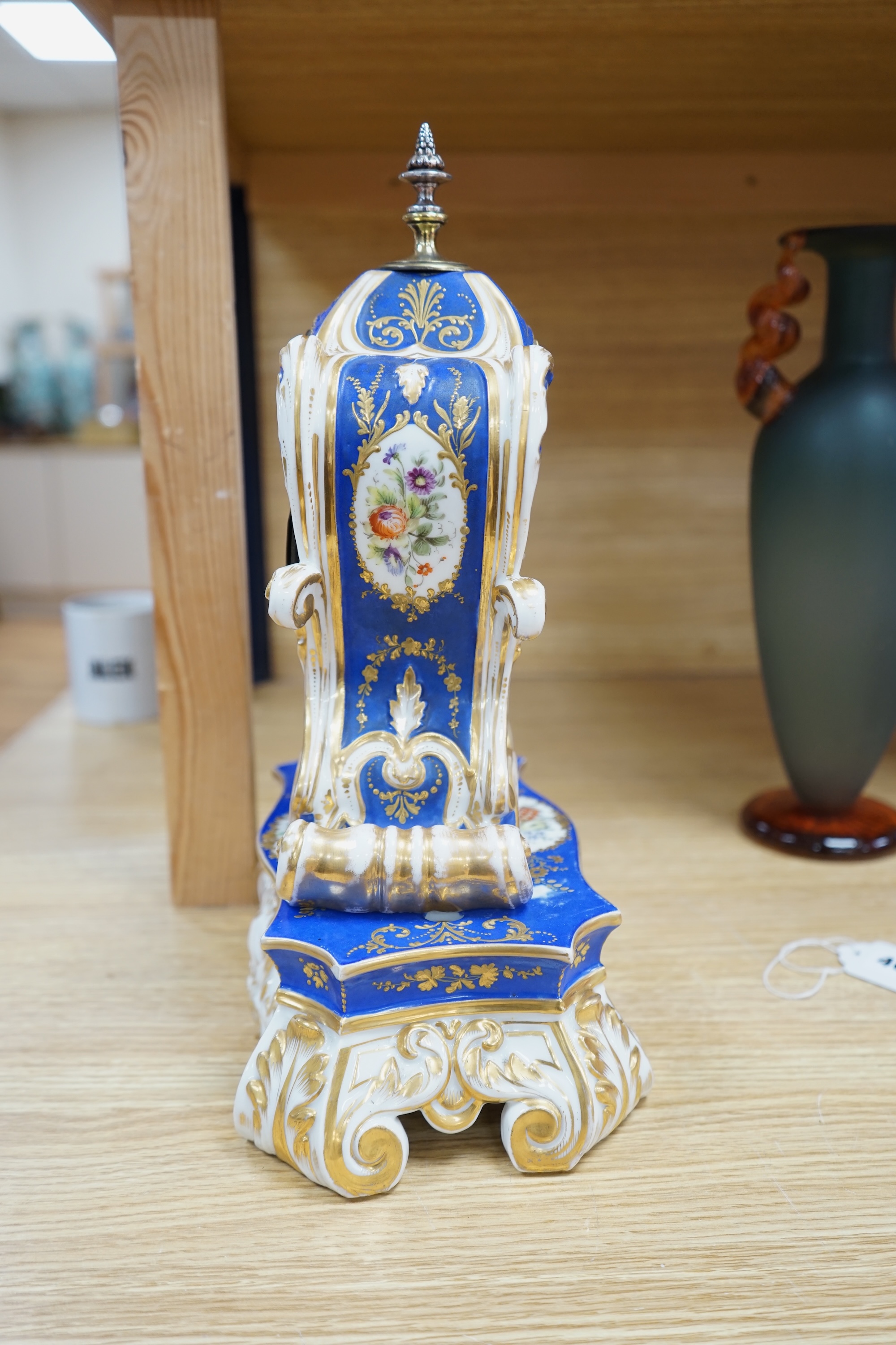 A French Paris porcelain waisted clock, striking on a bell, raised on original matching stand in the style of Jacob Petit c.1830, 37cm high. Condition - poor to fair